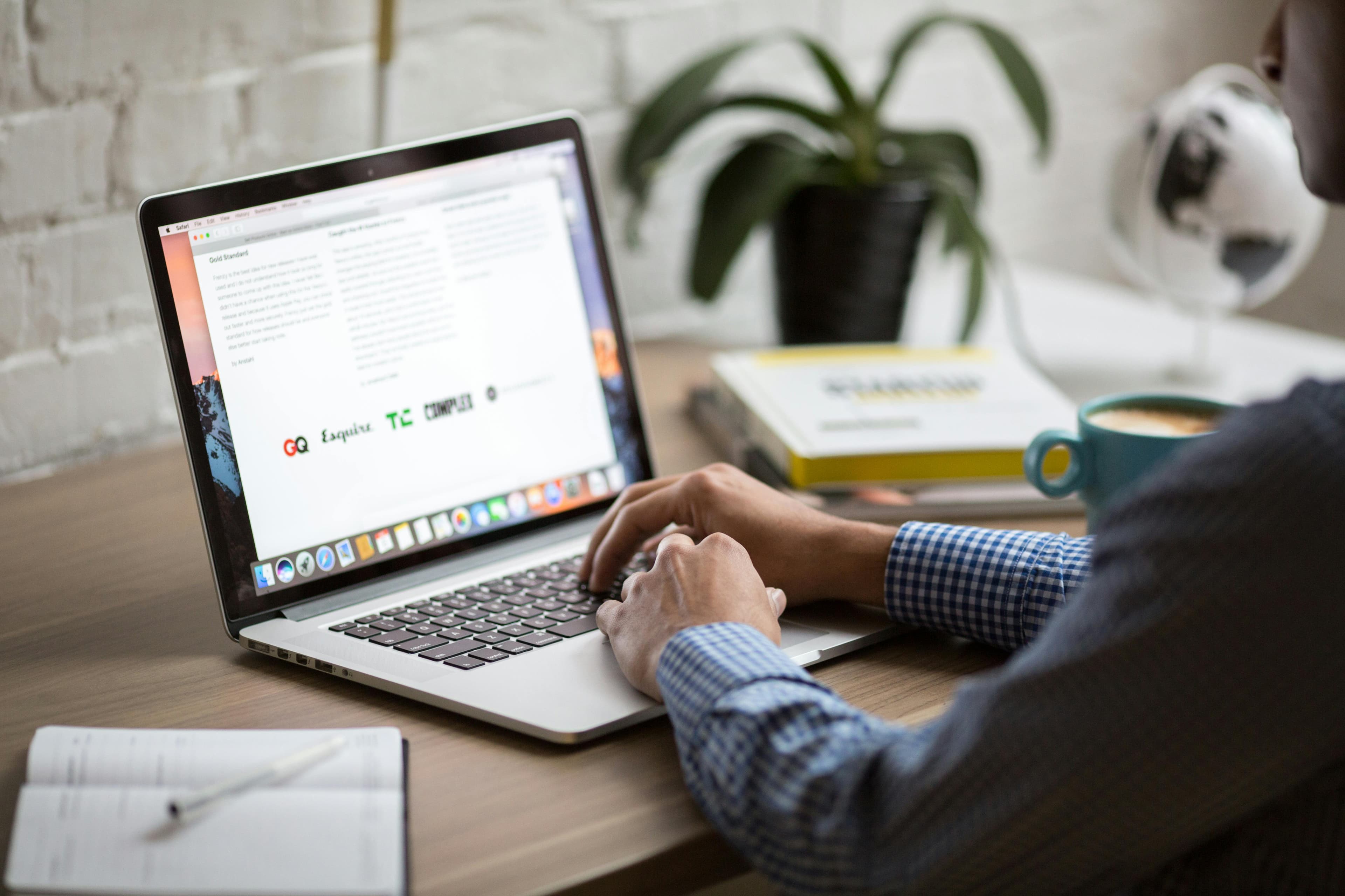 Person sitting in front of a laptop.